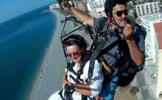 photo of a paragliding tandem flight with grandmother on the tropical coast of granada