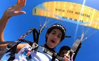 photo of flight with two-seater paraglider and girl on the tropical coast of granada