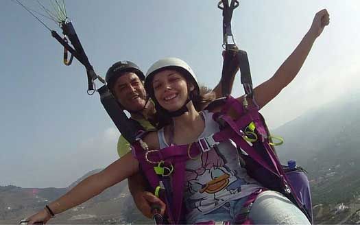 photo of a tandem paragliding flight on the tropical coast of granada 
